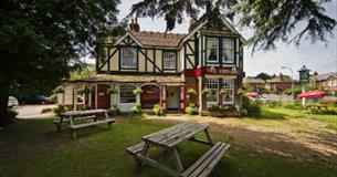 Outside view of The Cedars with seating area, Wootton, pub