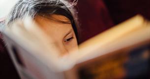 Child reading a book, book event at Quarr Abbey, Ryde, Isle of Wight, family event, what's on, children's activities