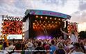 Crowds watching a band on the main stage at the Isle of Wight Festival, music event, what's on