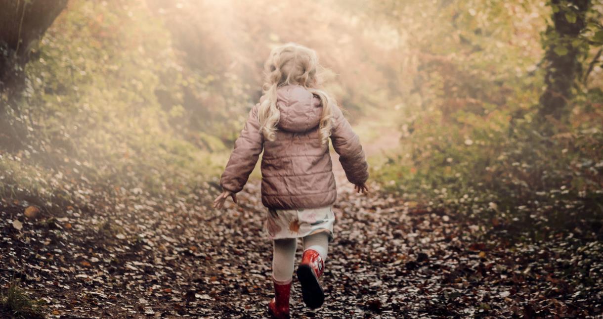 Child running in a forest