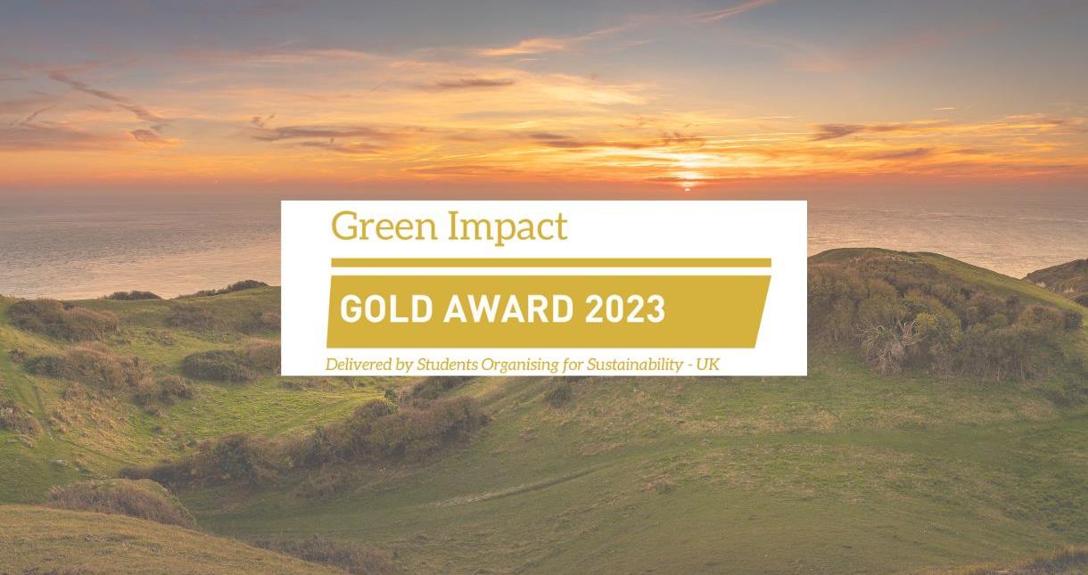 View of a sunset over the sea from the clifftop on the Isle of Wight with the Green Impact Gold Award 2023 logo