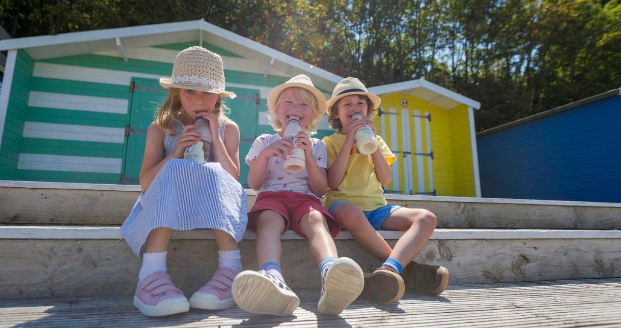 Children drinking milkshakes at Colwell Bay on the Isle of Wight