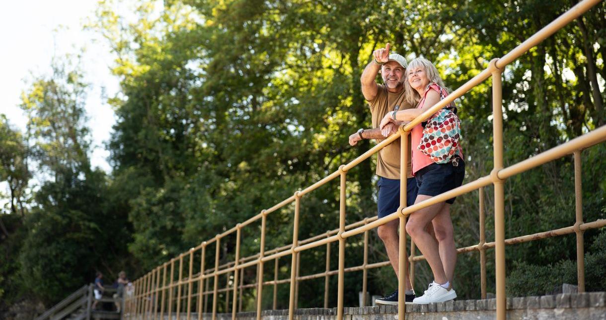 Couple standing on bridge at Seagrove Bay, Isle of Wight