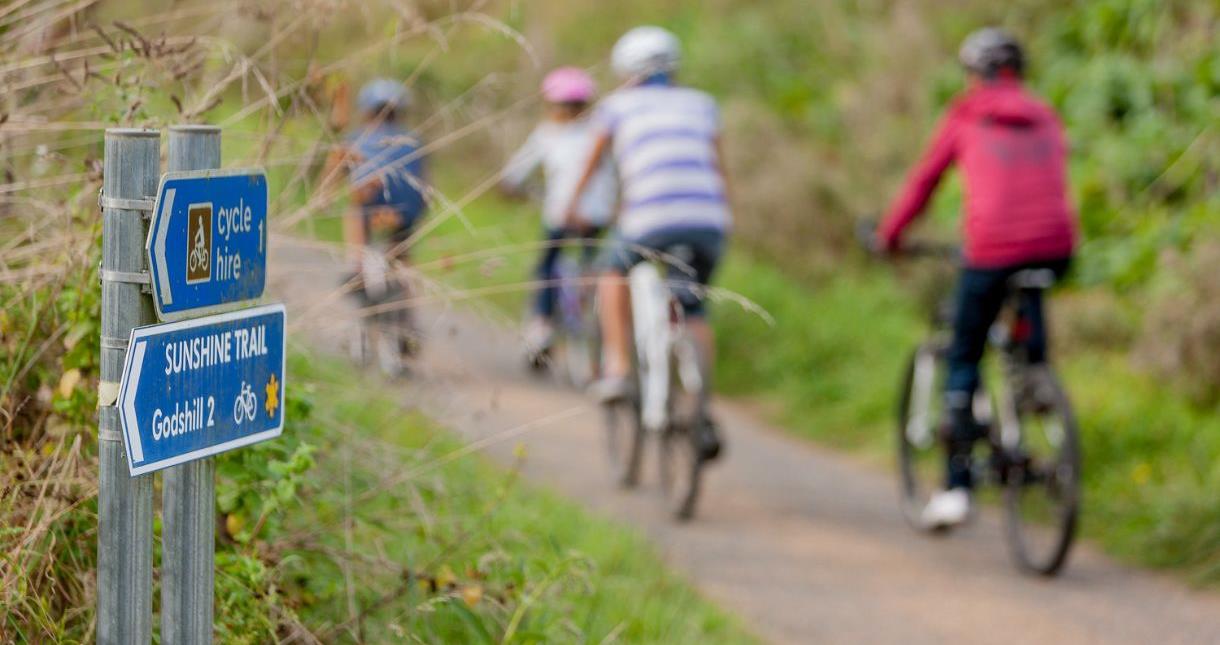 Family cycling along the Sunshine trail on the Isle of Wight