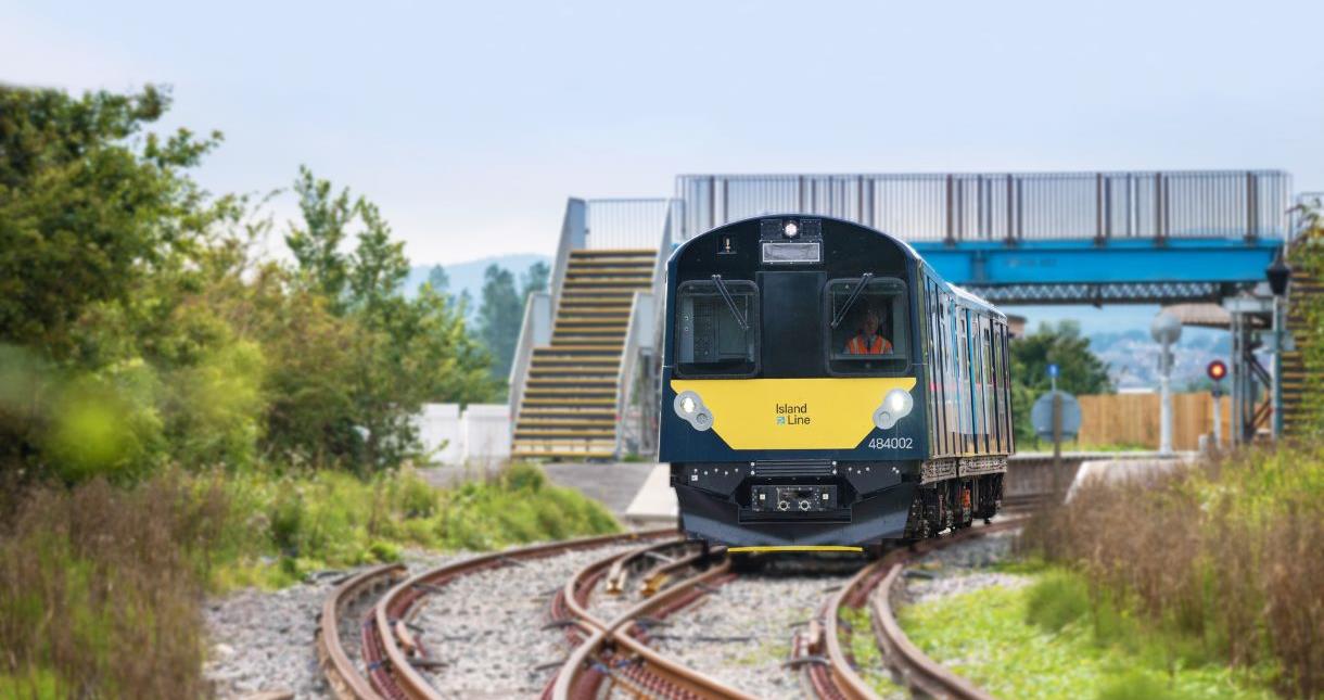 Island Line train travelling along railway tracks.