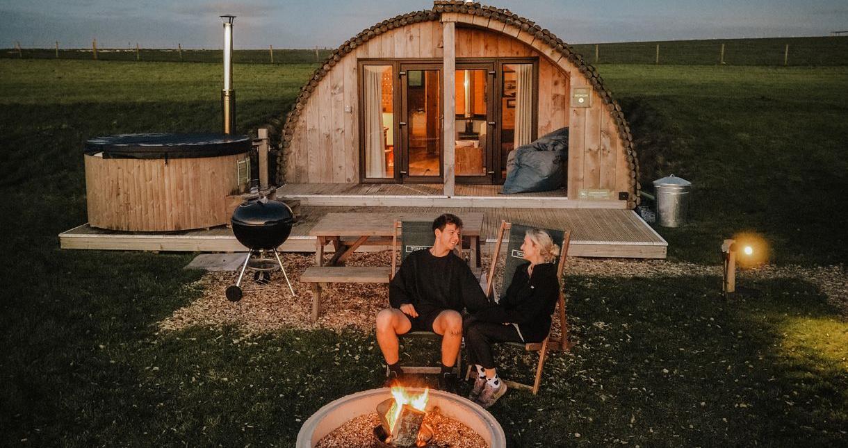 Couple sitting outside accommodation at Tapnell Farm on the Isle of Wight