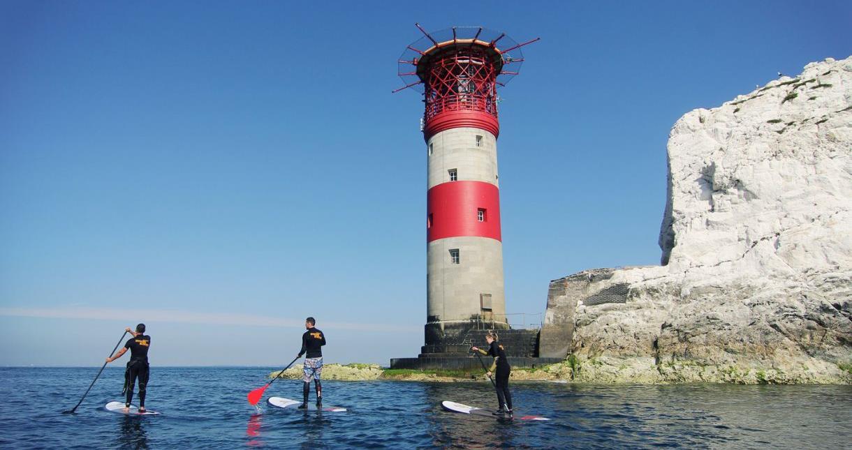 Group paddle boarding around the Needles