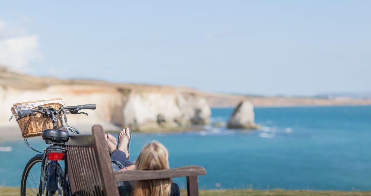 Lady laying on a bench admiring the sea views on the Isle of Wight