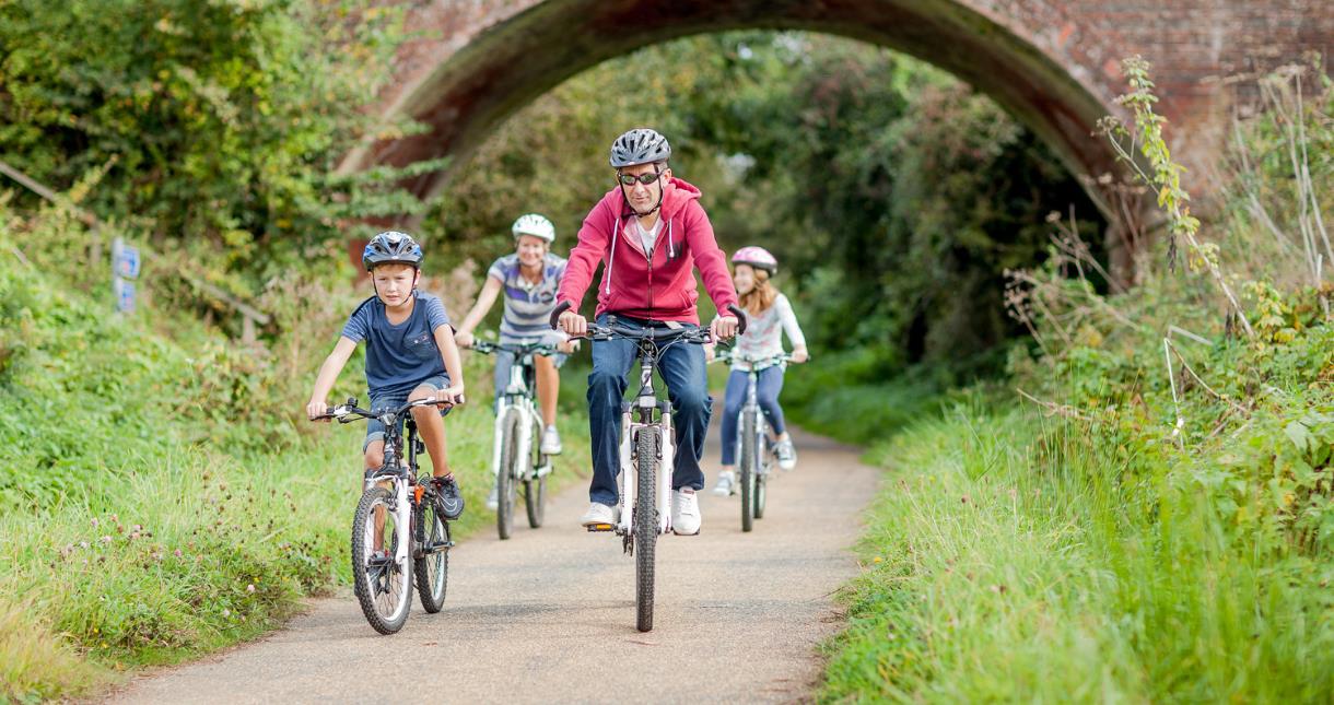 Family riding their bikes along the Red Squirrel trail on the Isle of Wight