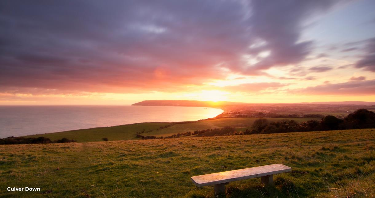 View of Sandown Bay from Culver Down with sunset in the background
