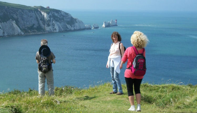 Group standing on cliff with The Needles in the background, Isle of Wight Guided Tours, Things to Do