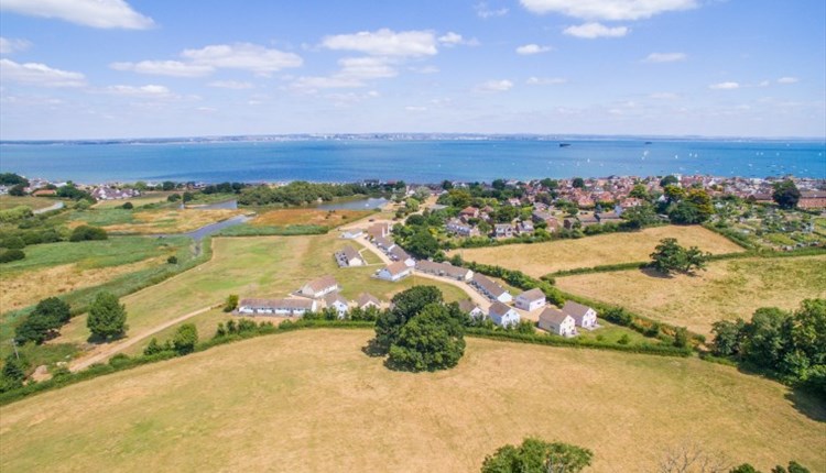 Isle of Wight, Accommodation, Seaview Holidays, image showing aerial view of Holiday cottages and views to sea.