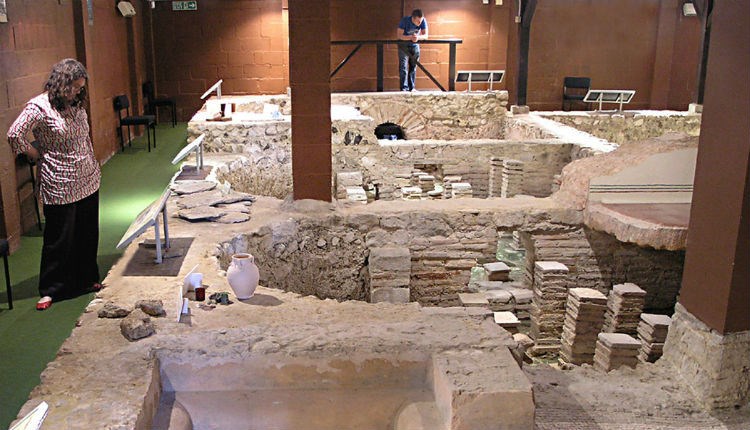 Lady viewing Roman bath at Newport Roman Villa, Isle of Wight, Things to Do