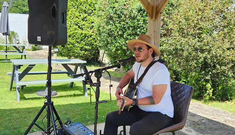 Ben Stubbs playing his guitar in the garden of Luccombe Hall Hotel, Shanklin, Isle of Wight, live music, performance,