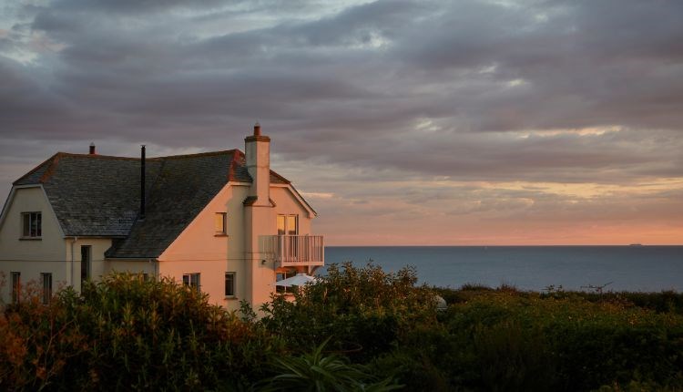 Outside view of Flackstead with the sun setting behind, property with Classic Cottages, Isle of Wight, self catering, accommodation, luxury, cottages