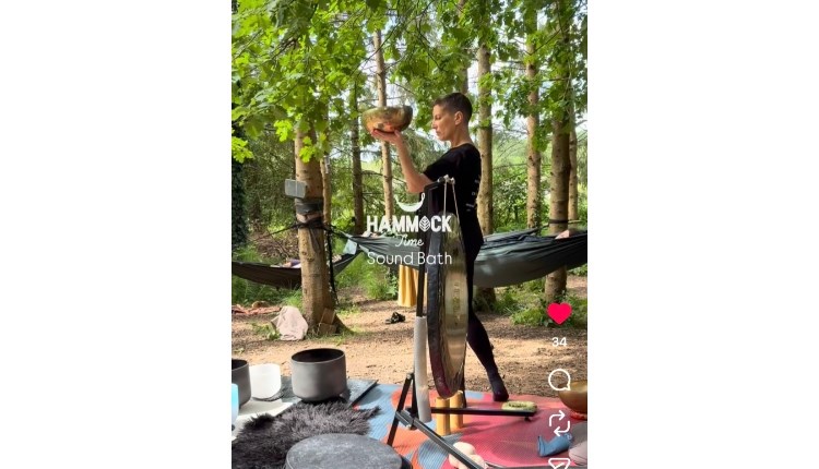 visit isle of wight, things to do, woman in forest setting for hammock sound bath