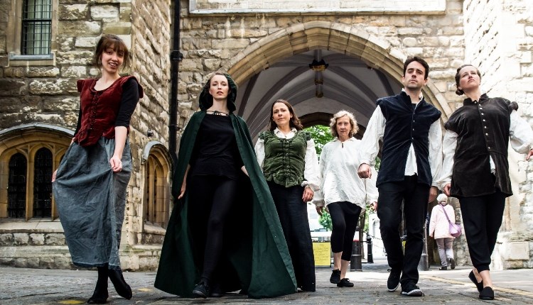 visit isle of wight, things to do, actors in Shakespearean dress walking along a street.