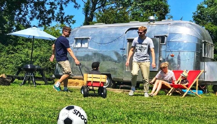 Family enjoying the outside area surrounding the American Airstream at Retro Staycations, unique place to stay, Ryde, Isle of Wight