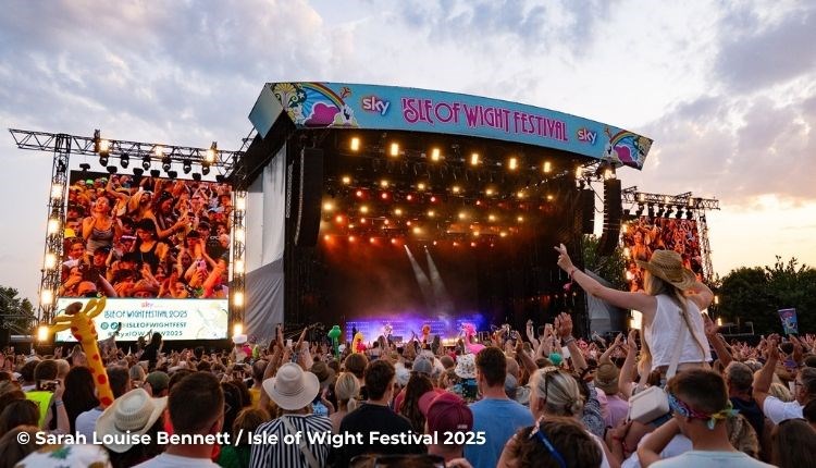 Crowds watching a band on the main stage at the Isle of Wight Festival, music event, what's on