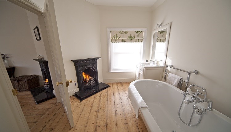 Roll-top bath with open fire at Signal Point, Ventnor Botanic Garden, Self Catering, Isle of Wight