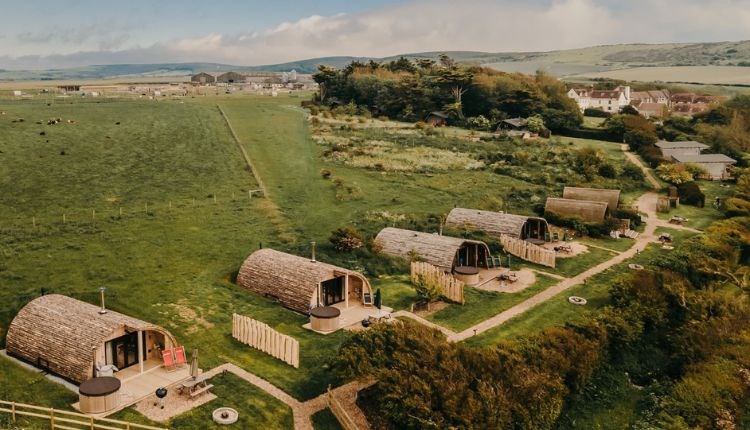 Aerial view of Tapnell Farm with exterior view of modulogs, Tom's Eco Lodge, self-catering, West Wight, Isle of Wight