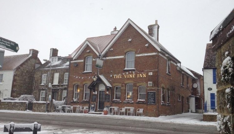 Outside view of The Vine Inn in the snow, pub, St Helens