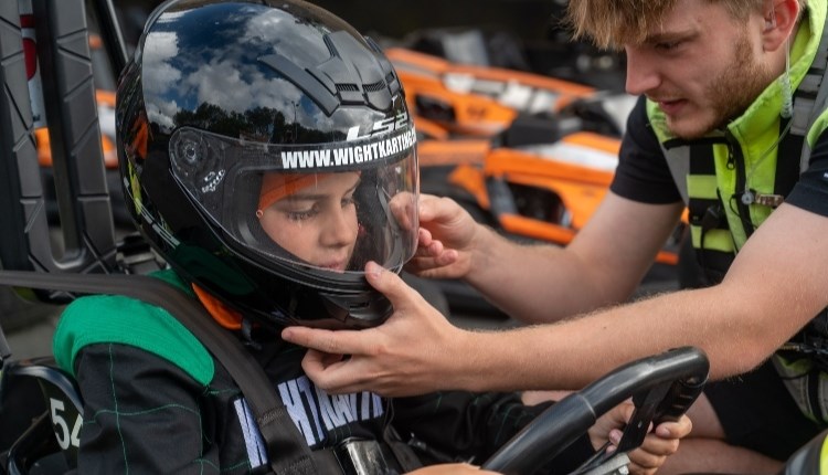 Man helping child with helmet before karting at Wight Karting, Ryde, Children's Events, junior track days