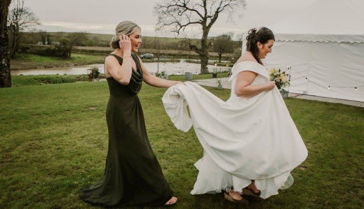 Isle of Wight, Wedding Venue, Westover Farm, Calbourne, Bride and Bridesmaid walking in front of lake