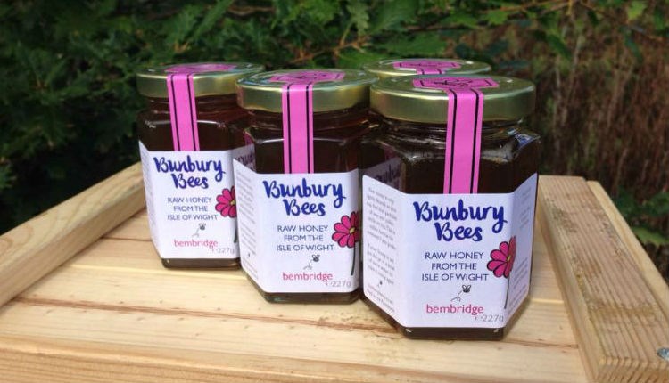 Pots of honey produced by Bunbury Bees placed on a tray outside, local producers, Isle of Wight, local produce, let's buy local