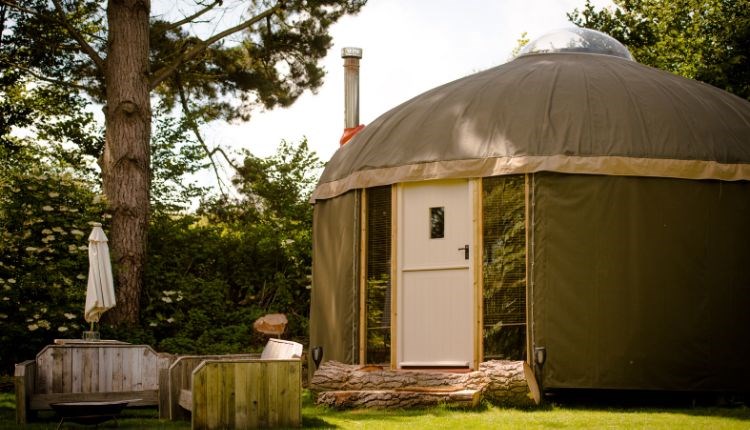 Outside view of yurt with outside seating at The Garlic Farm, Isle of Wight, unique place to stay