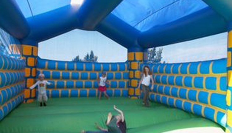 Children playing on a bouncy castle in the grounds of the Horse & Groom, eating out, local produce, Isle of Wight