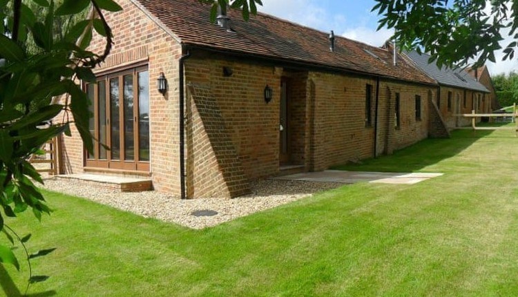 Outside view of Lacewood barn surrounded by garden, Fernhill Barns, Wootton, Isle of Wight, self-catering