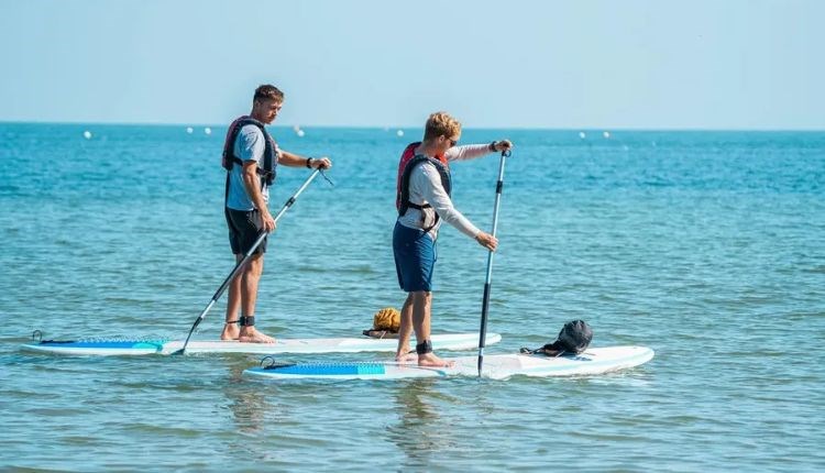 Couple paddleboarding on the water, SupDog kayak and paddleboard hire, Colwell beach, Isle of Wight, sports activities, water sports
