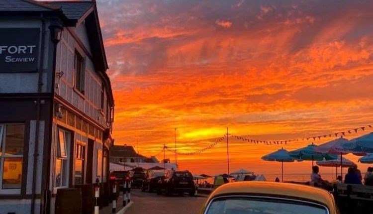 Outside view of The Old Fort with a sunset over the sea, Seaview, Isle of Wight, food & drink