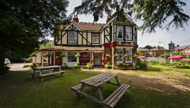 Outside view of The Cedars with seating area, Wootton, pub