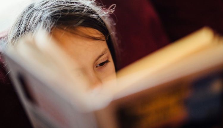 Child reading a book, book event at Quarr Abbey, Ryde, Isle of Wight, family event, what's on, children's activities
