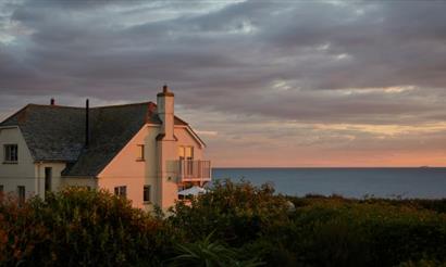 Outside view of Flackstead with the sun setting behind, property with Classic Cottages, Isle of Wight, self catering, accommodation, luxury, cottages