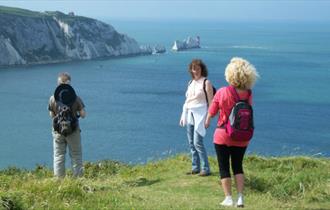 Group standing on cliff with The Needles in the background, Isle of Wight Guided Tours, Things to Do