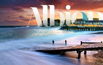 Isle of Wight, Accommodation, The Albion Hotel, FRESHWATER BAY, image of logo overlaying view of the hotel across the bay