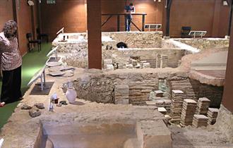 Lady viewing Roman bath at Newport Roman Villa, Isle of Wight, Things to Do