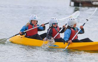 Children rowing in a canoe at UKSA, Easter fun day events, watersports, children activities, what's on, Cowes, Isle of Wight