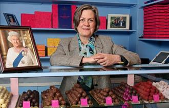 Chantal Coady with a photo of the late Queen and a variety of chocolate, talk, event, what's on, Cowes, Isle of Wight