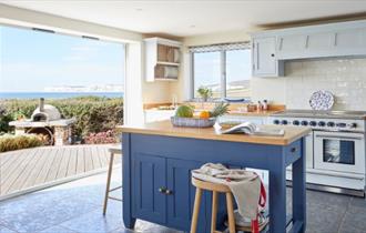 Kitchen at Flackstead with doors leading out to the patio with sea views, Wight Locations property, Isle of Wight, self catering, cottages and houses,