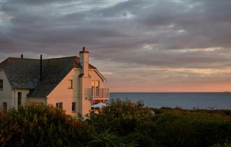 Outside view of Flackstead with the sun setting behind, property with Classic Cottages, Isle of Wight, self catering, accommodation, luxury, cottages