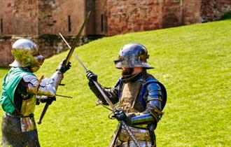 Two armoured knights fighting at Knights' Tournament at Carisbrooke Castle, history event, what's on, Isle of Wight