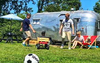 Family enjoying the outside area surrounding the American Airstream at Retro Staycations, unique place to stay, Ryde, Isle of Wight