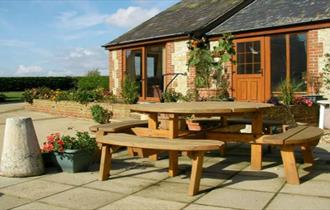 Outside view of Rose Cottage with outdoor picnic table, Atherfield Green Farm Holiday Cottages, Chale, Self Catering