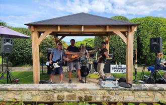 The Spammy Oatis performing in the garden at Luccombe Hall Hotel, Shanklin, Isle of Wight, live music, performance