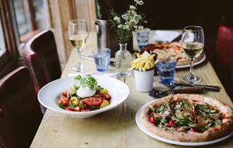 Pizza, salad, fries and wine at The Coast Bar & Dining Room, Cowes, Eat & Drink - Copyright: Maria Bell