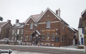 Outside view of The Vine Inn in the snow, pub, St Helens